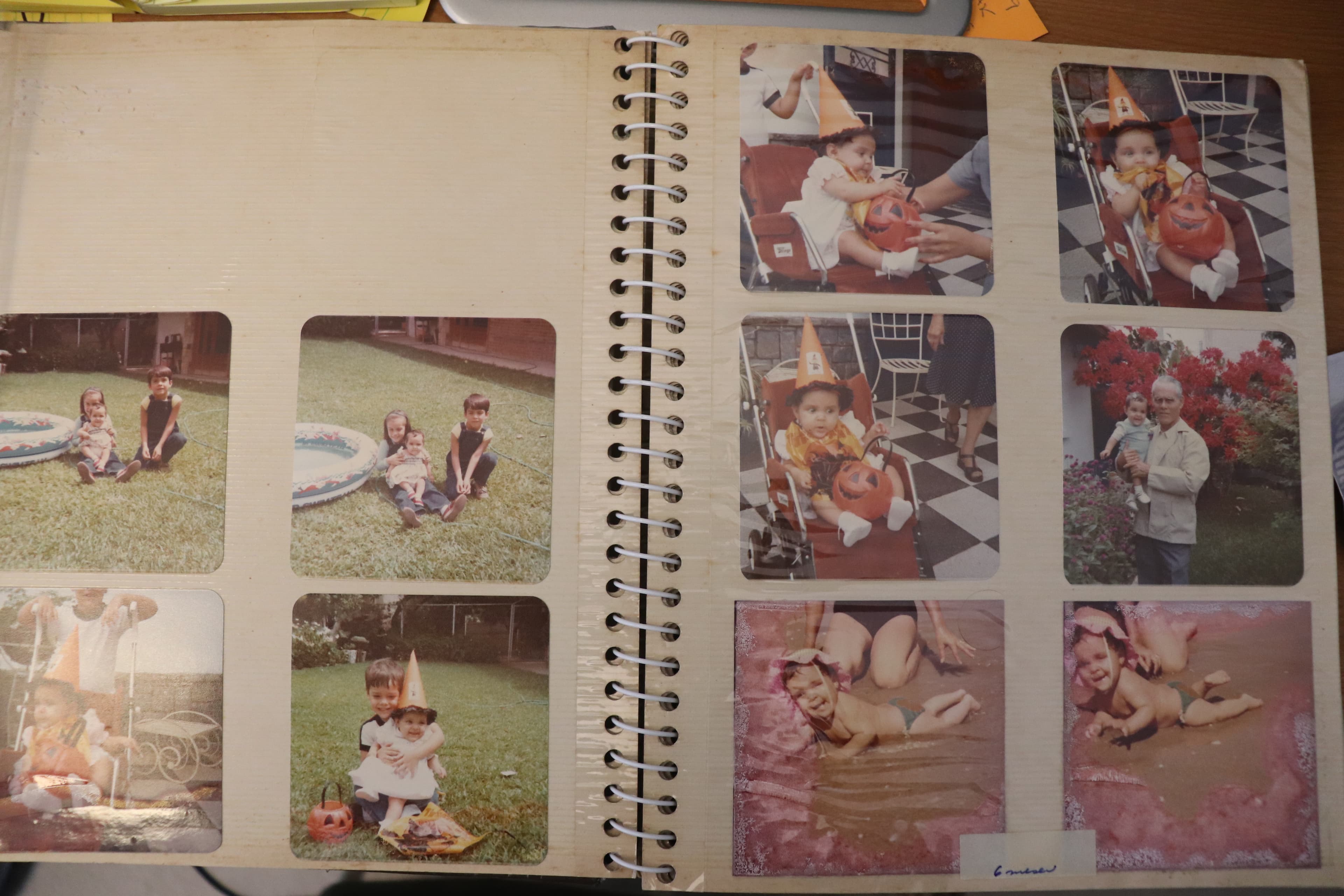 Open magnetic photo album with family photos